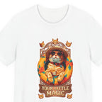 Close-up of the Your Little Magic pool float cat print: ginger cat in a straw hat and sunglasses in an orange hibiscus pool float, ribbon reading Your Little Magic, on the White tee