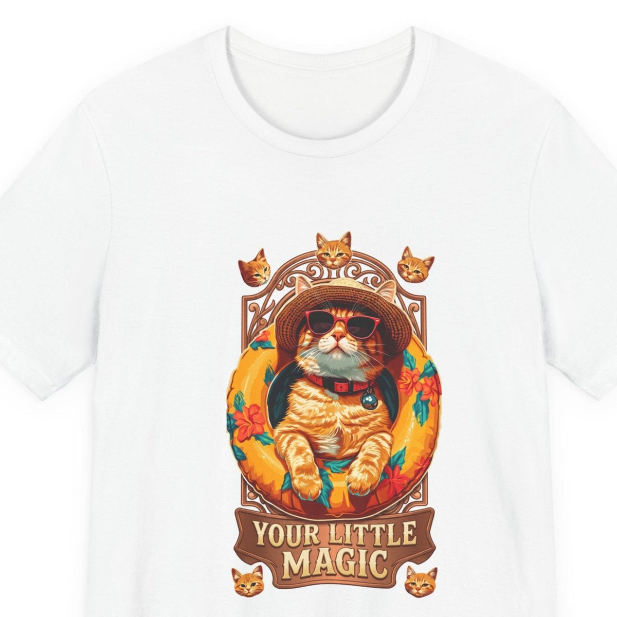 Close-up of the Your Little Magic pool float cat print: ginger cat in a straw hat and sunglasses in an orange hibiscus pool float, ribbon reading Your Little Magic, on the White tee